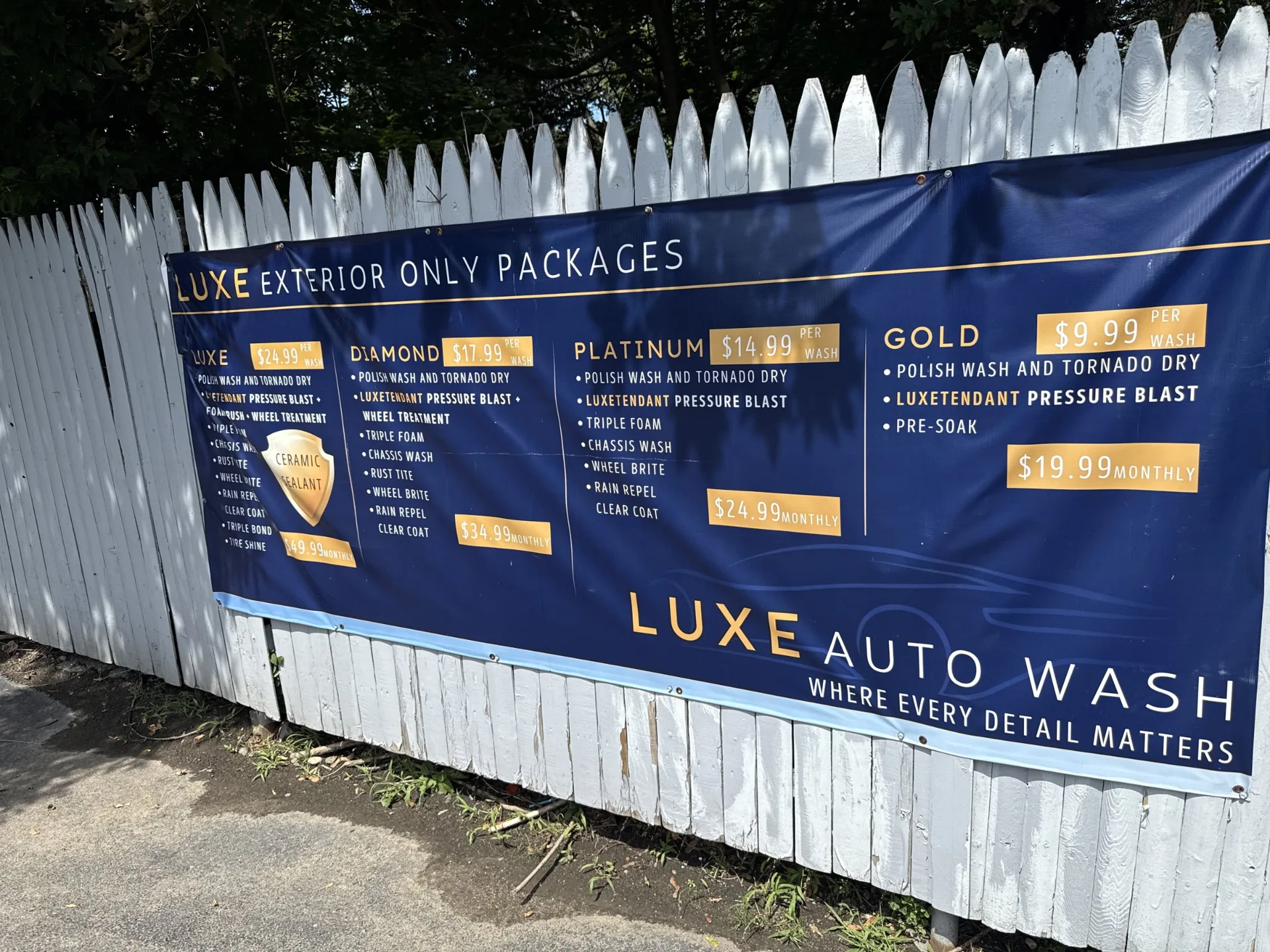 The Luxe Auto Wash price board showing the Gold, Platinum, Diamond and Luxe packages